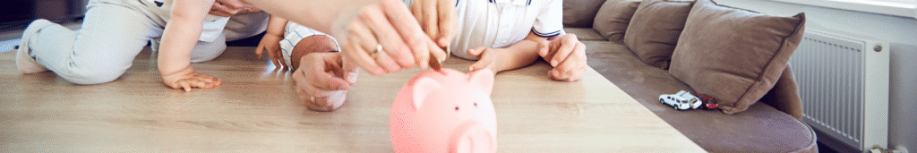 family putting money in piggy bank