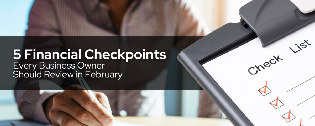 Business owner reviewing a checklist while writing in a notebook, representing financial checkpoints to review in February.